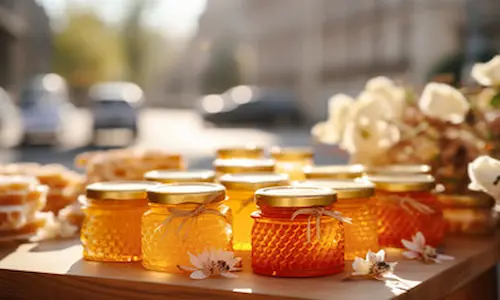 pots of home made honey on a table